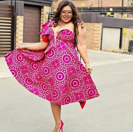 Deep-pink one-shoulder ruffle midi dress with large circular African print