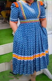 Blue geometric stripe midi dress with ruffle hem, short sleeves, square neckline.
