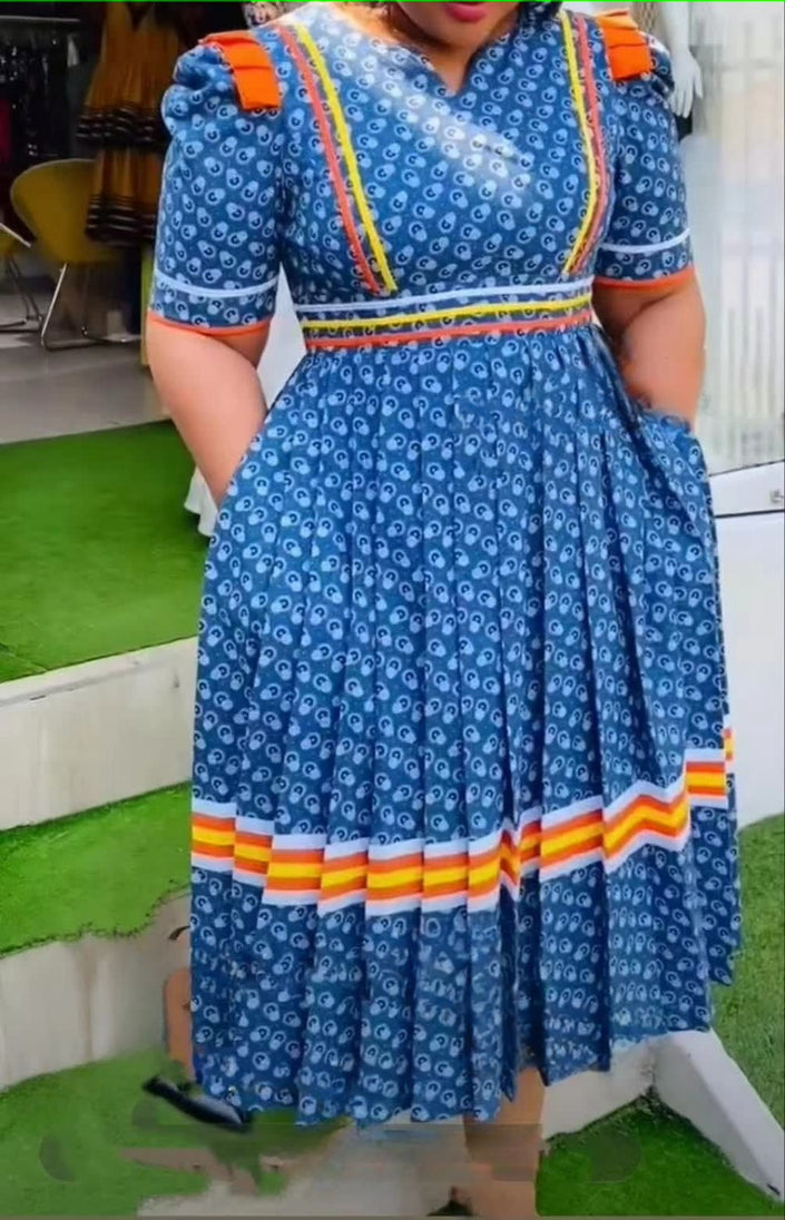 Blue geometric stripe midi dress with ruffle hem, short sleeves, square neckline.
