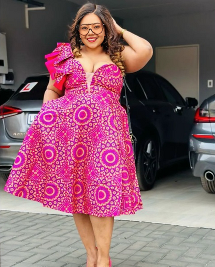 Deep-pink one-shoulder ruffle dress with circular African print and layered shoulder ruffle