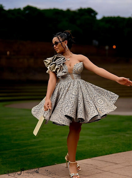 Light beige one-shoulder ruffle dress with circular African print, flared skirt