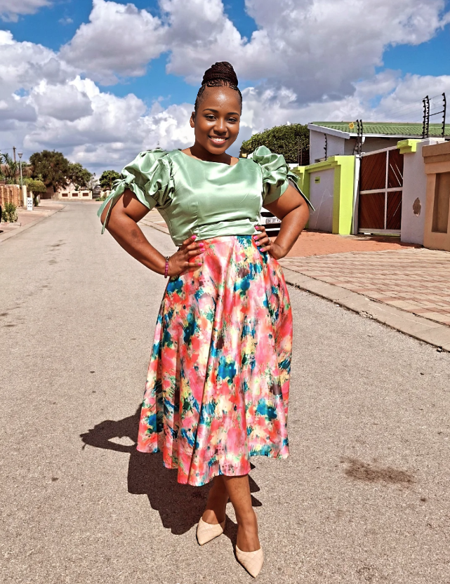 Mint green puff-sleeve blouse with colorful floral knee-length skirt, two-piece set