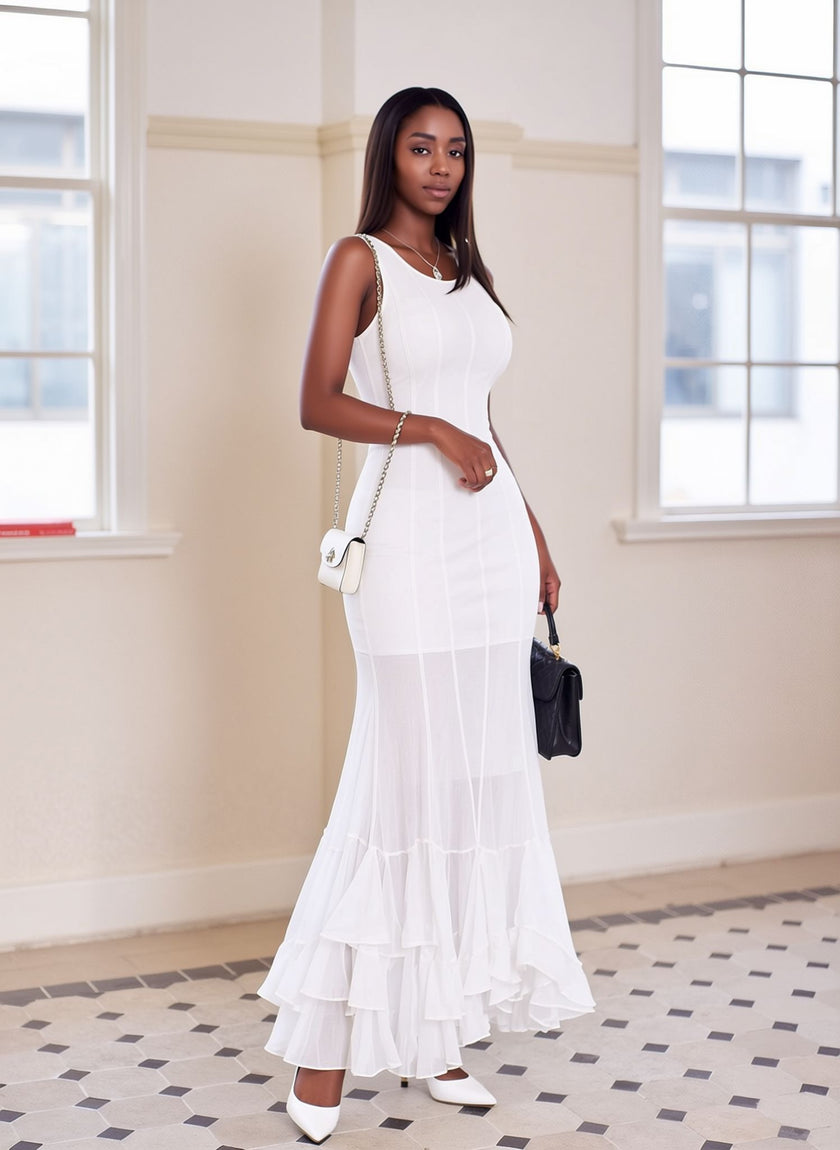 White sleeveless sheer maxi dress with a fitted bodice and layered ruffle hem