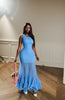 Blue sleeveless sheer maxi dress with a fitted bodice and tiered ruffle hem