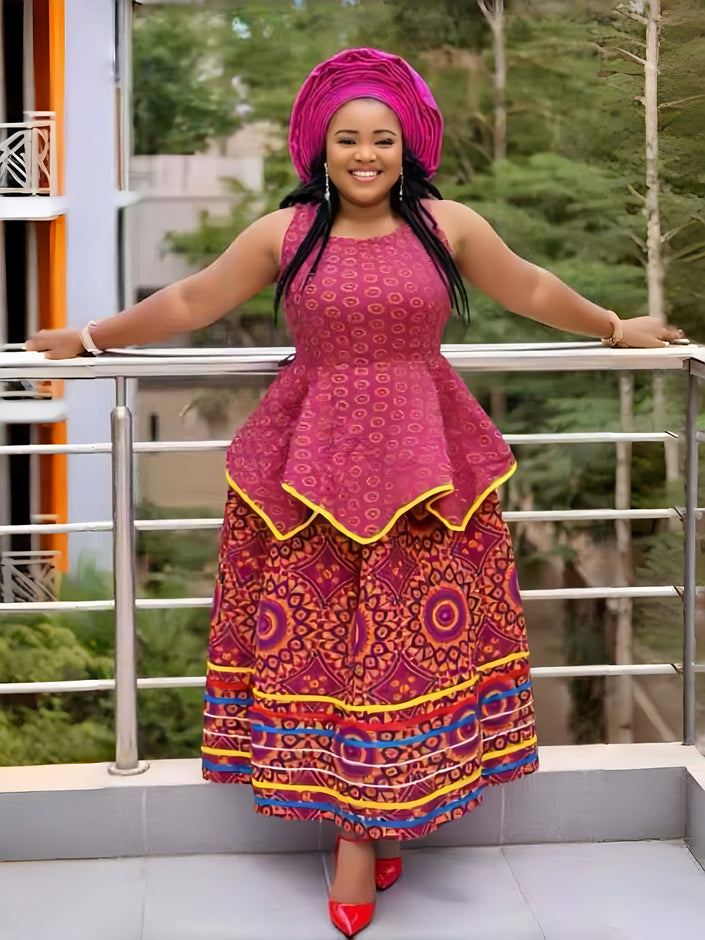 Sleeveless maxi dress with high waist and flared skirt, bold African print in magenta and yellow