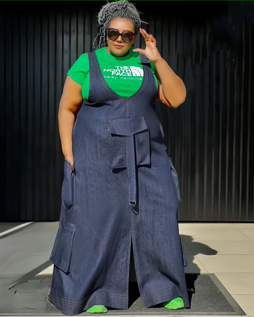 Plus size denim overall dress with front pockets, sleeveless bib and wide skirt