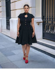 Black vintage dress with cutout neckline, short sleeves, button front, flared hem