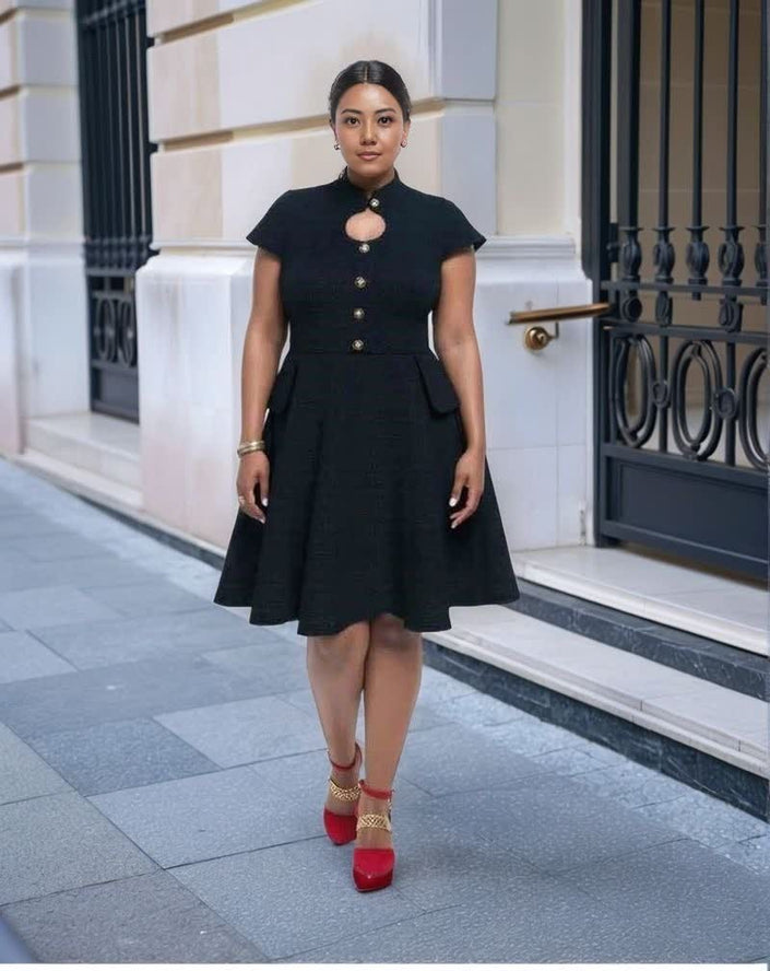 Black vintage dress with cutout neckline, short sleeves, button front, flared hem