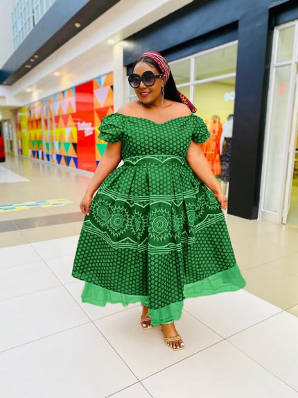 Green midi dress with ruffle neckline and circular motif skirt, short sleeves