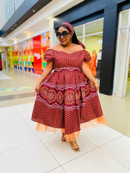 Burgundy midi dress with ruffle neckline and circular motif skirt, short sleeves