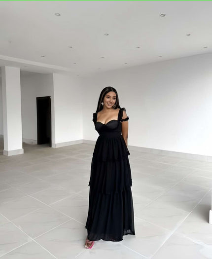 Black tiered ruffle maxi dress with sweetheart neckline, sleeveless with shoulder ruffles.