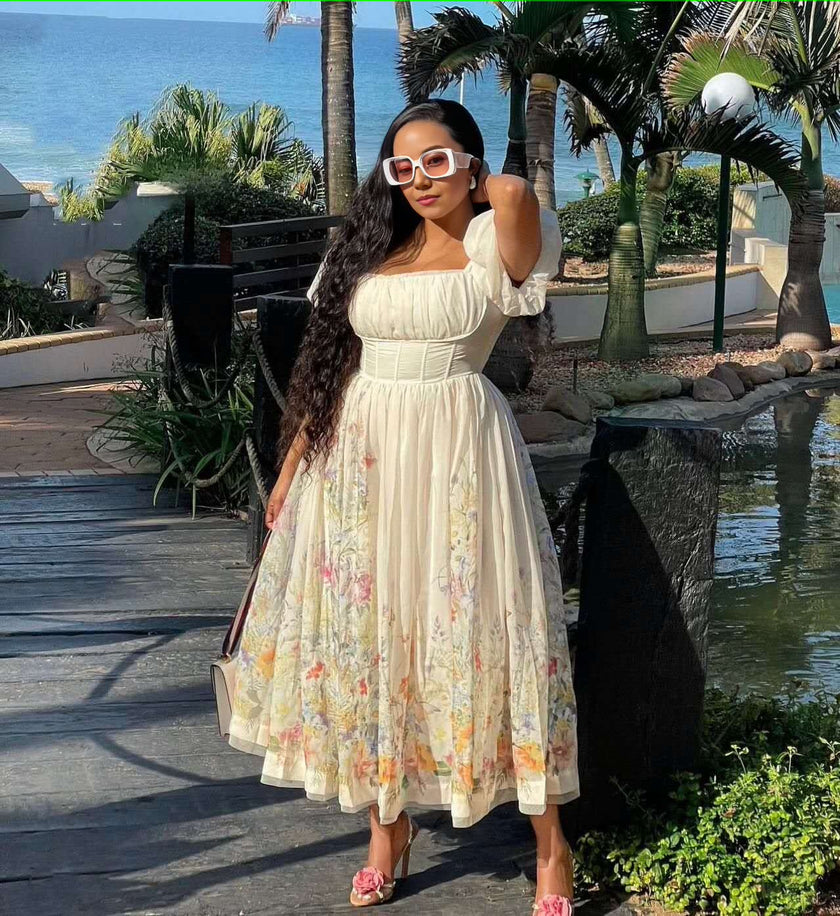 Cream midi dress with puff sleeves, square neckline, and embroidered floral pattern