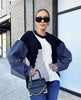 Denim-sleeve knit sweater with dark navy body and white buttoned front panel