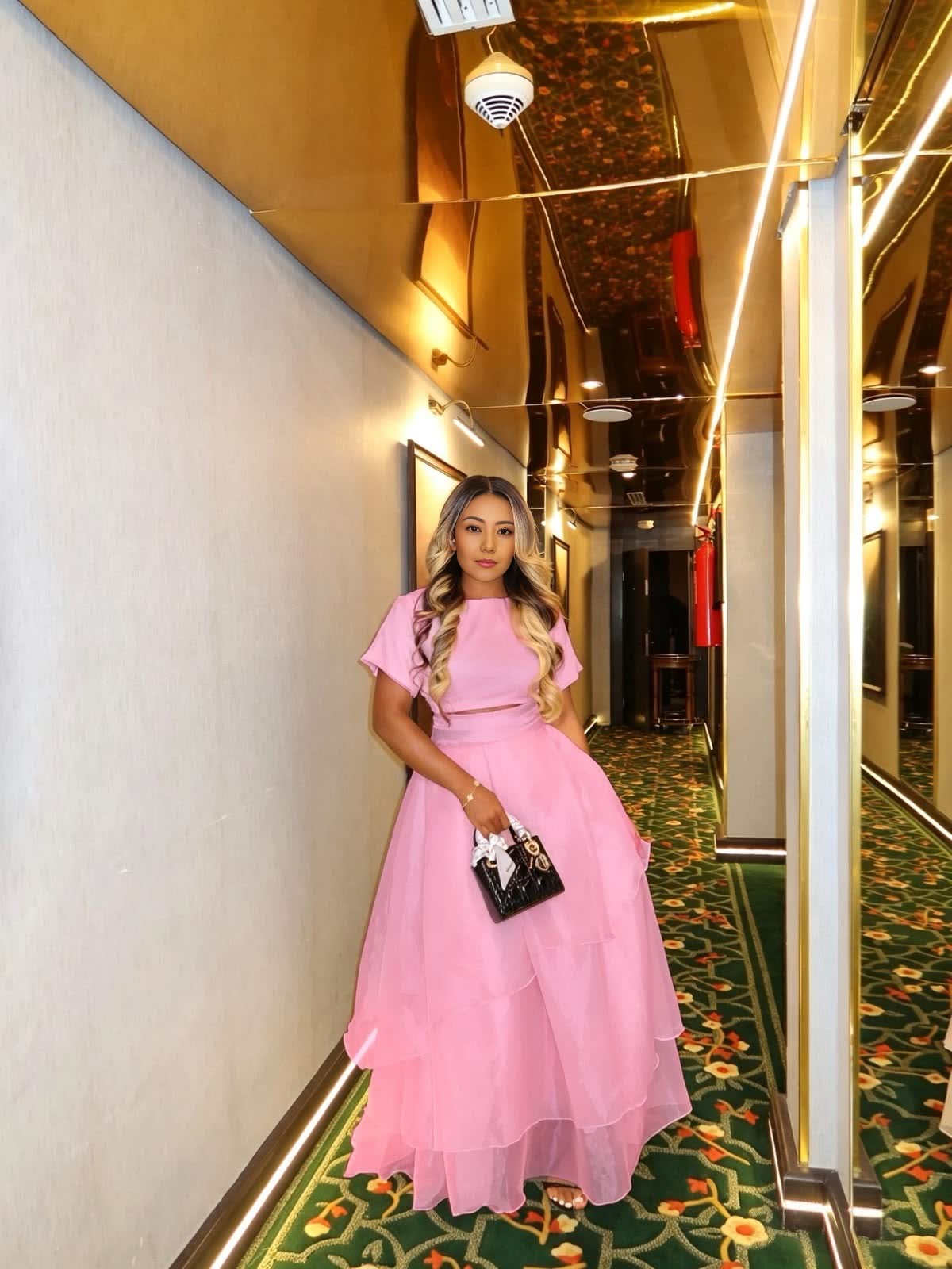 Pink two-piece crop top and layered maxi skirt set with short sleeves