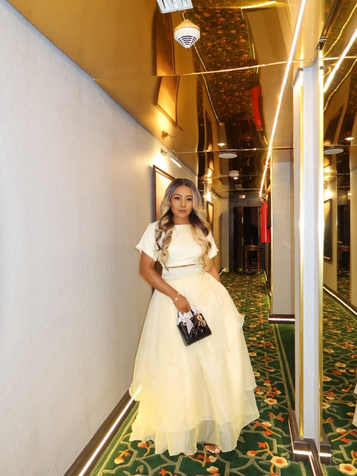 Cream two-piece crop top and layered maxi skirt set with short sleeves