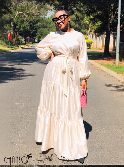 Light beige maxi dress with mock neck, balloon sleeves, tiered hem and tie belt