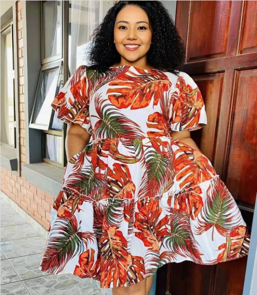 Floral midi dress with puff sleeves, white base with orange tropical leaf print