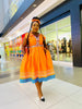 Orange maxi dress with embroidered neckline and colorful patterned hem border