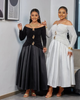 Off-shoulder maxi dress with gold buckle detailing, black and white shown.