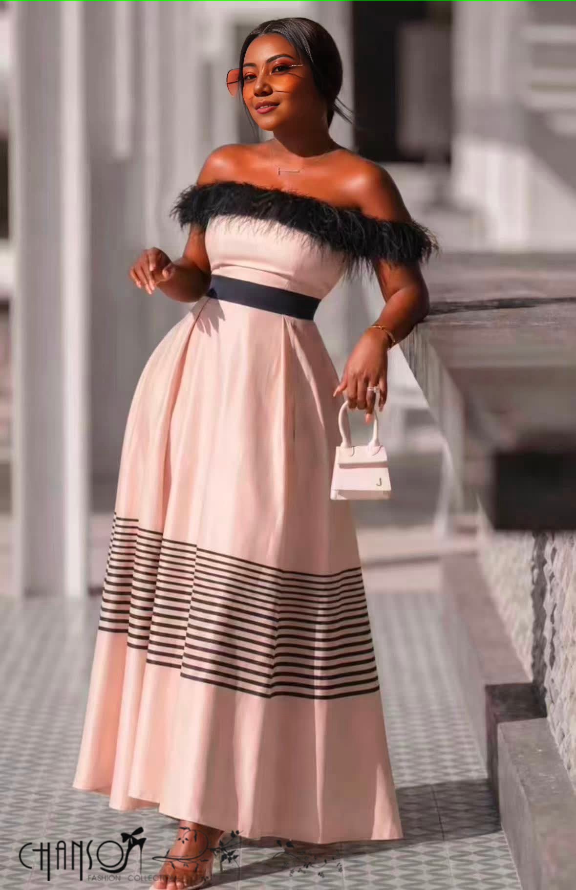 Women's pink off shoulder Traditional Dress with black feather trim and striped maxi hem