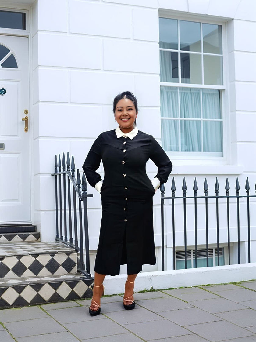 Black midi dress with white contrast collar, long sleeves, and button front