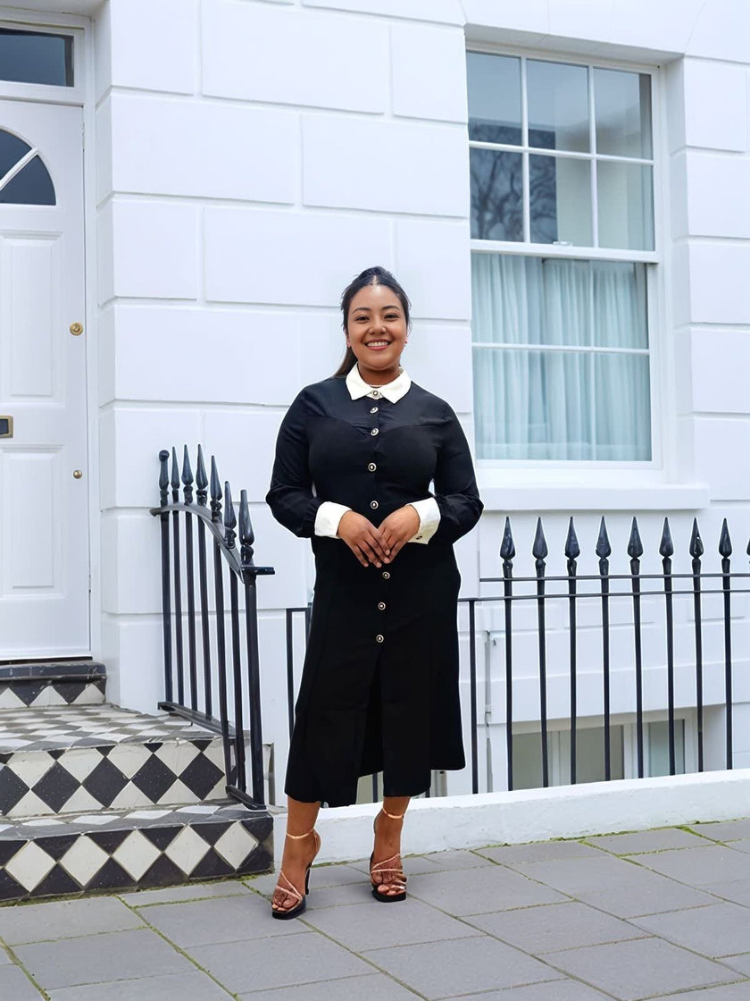 Black midi dress with white contrast collar, buttoned bodice, long sleeves