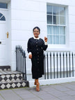 Black midi dress with white collar and long sleeves, centered button placket