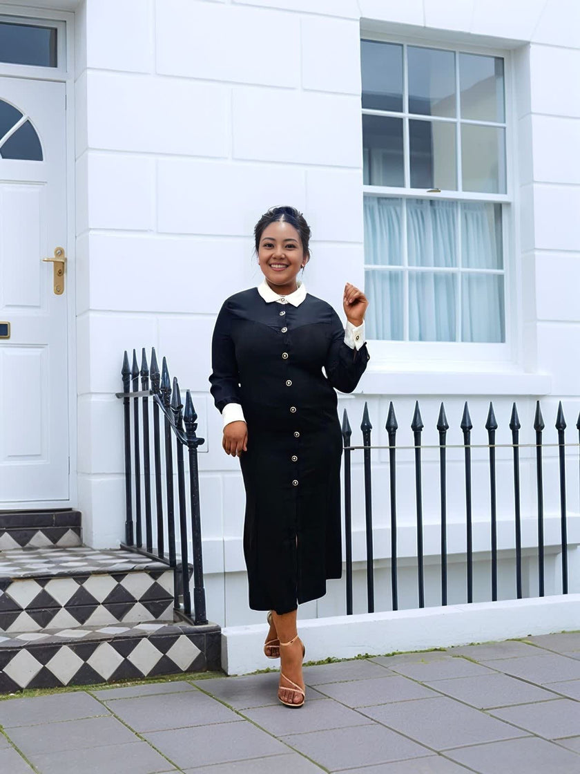 Black midi dress with white collar and long sleeves, centered button placket