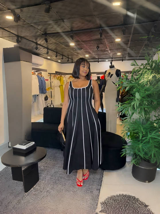 Black and white striped sleeveless maxi dress with square neckline and vertical pattern