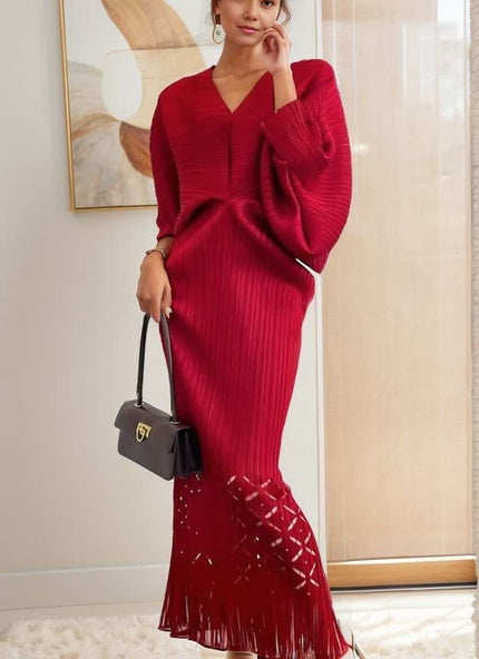 Red knit maxi dress with V-neck, long loose sleeves, ribbed knit, tassel fringe hem