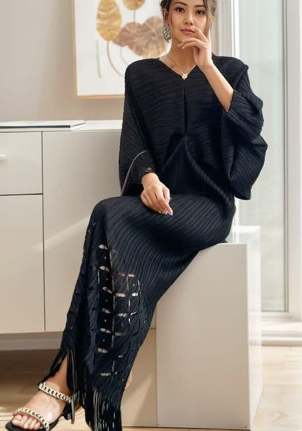 Dark knit maxi dress with V-neck, long loose sleeves, ribbed knit, tassel fringe hem