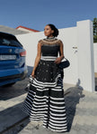 Black maxi dress with lace neckline and striped tiered skirt, sleeveless