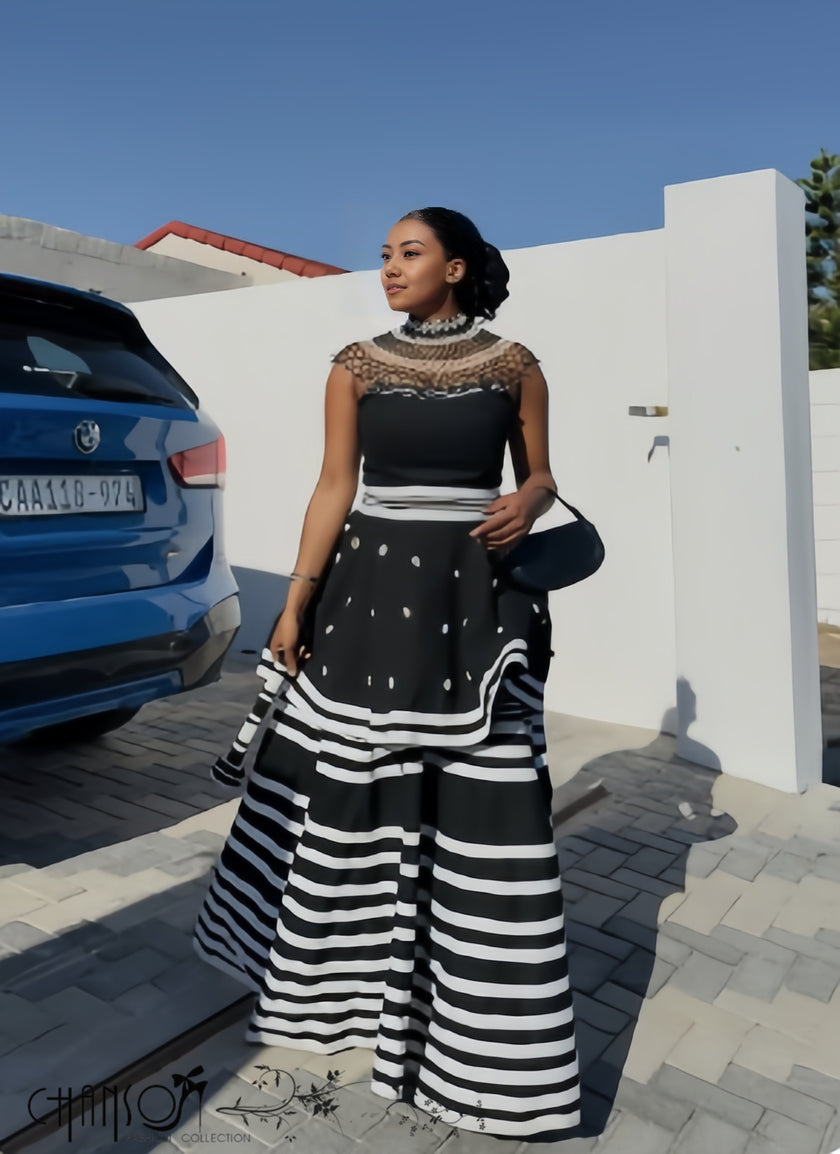 Black maxi dress with lace neckline and striped tiered skirt, sleeveless
