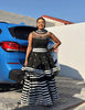 Black maxi dress with lace high neckline and striped flared skirt