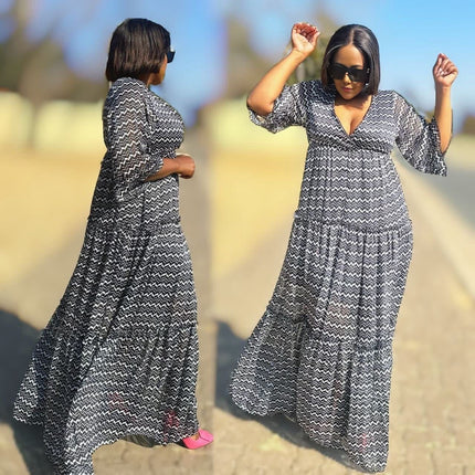 Zigzag maxi dress with V-neck, short sleeves, flared hem; black-and-white pattern