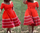 Plus size A-line dress in red with short sleeves and striped hem, gathered waist tie.
