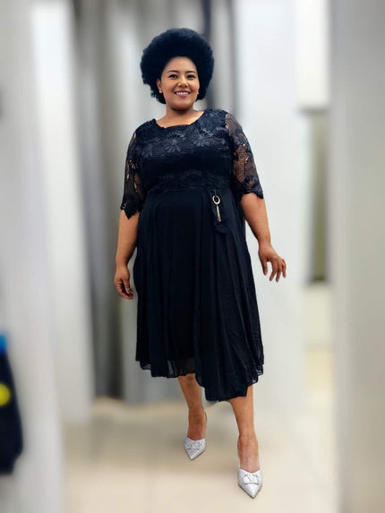 Black lace midi dress with waist ring detail, short sleeves, flowing skirt