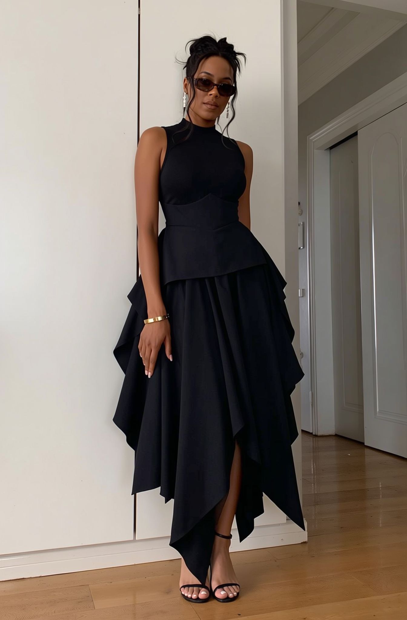 Black two-piece set with sleeveless high-neck top and high-waist asymmetric hem skirt
