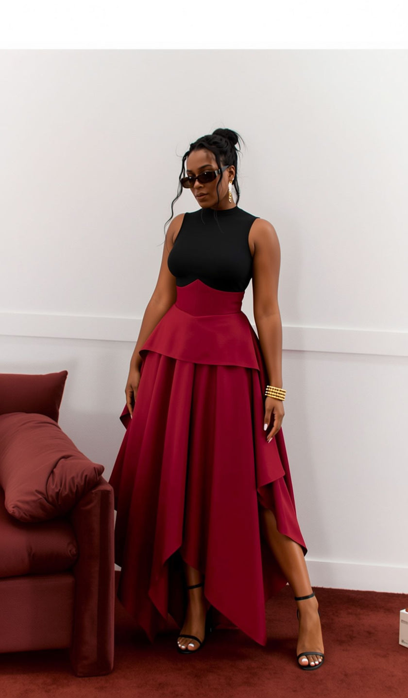 Maroon two-piece set with sleeveless high-neck top and high-waist asymmetric hem skirt