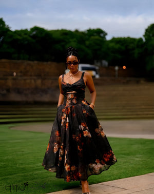 Black spaghetti-strap cutout midi dress with floral print, twisted bust and full skirt