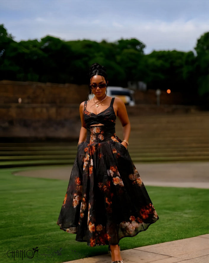 Black spaghetti-strap cutout midi dress with floral print, twisted bust and full skirt