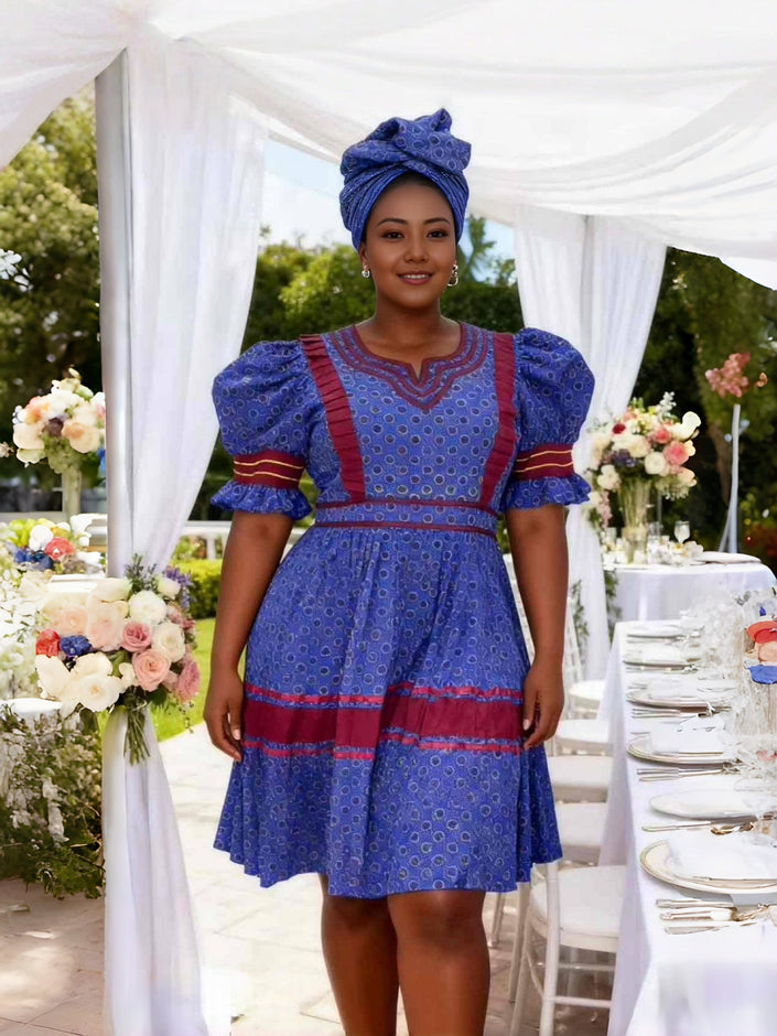 Blue puff-sleeve dress with circular motif and red trim, V-neck