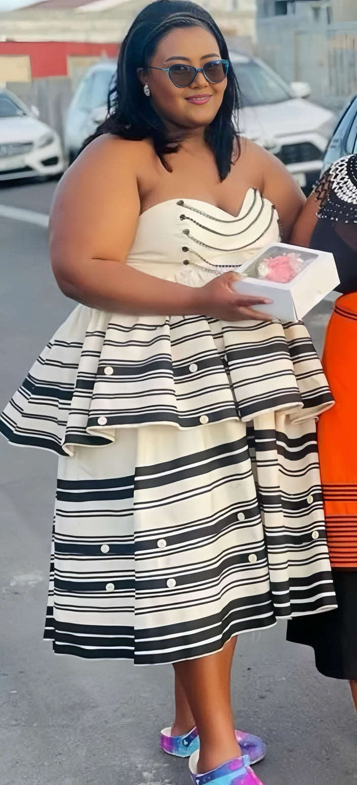 Sleeveless tiered dress with navy-and-white striped bodice and flared skirt