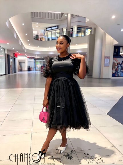 Women’s black midi dress with ruffle sleeves, waist tie, and layered tulle skirt