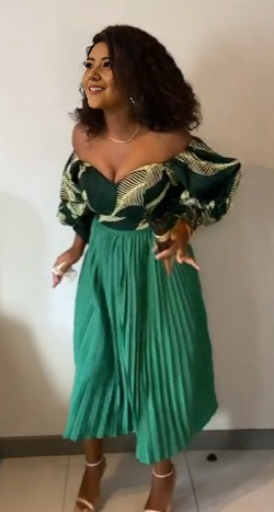 Off-shoulder pleated skirt outfit in teal green with ruffled sleeves and printed trim