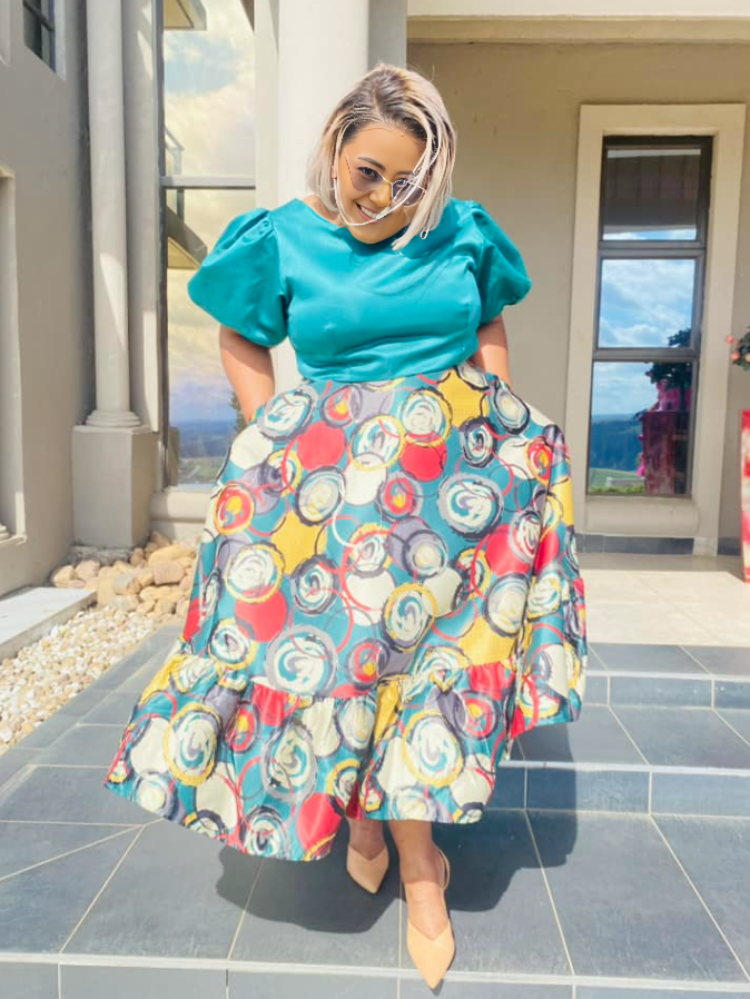 Printed midi dress with puff sleeves; turquoise top and colorful circular skirt