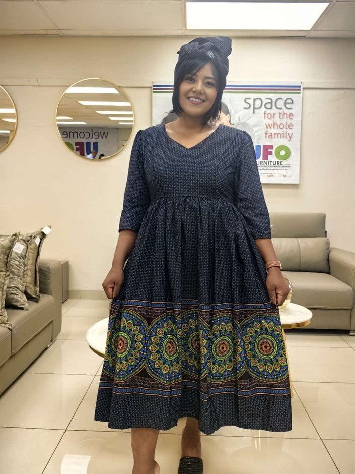 Navy midi dress with V-neck, flared skirt, and colorful ethnic border print