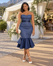 Strapless navy patterned dress with a fitted bodice, waist sash, and flared mermaid hem