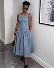 Light blue sleeveless denim midi dress, fitted waist and flared skirt