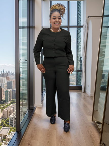 Black button-front top with straight-leg pants, full-length indoors